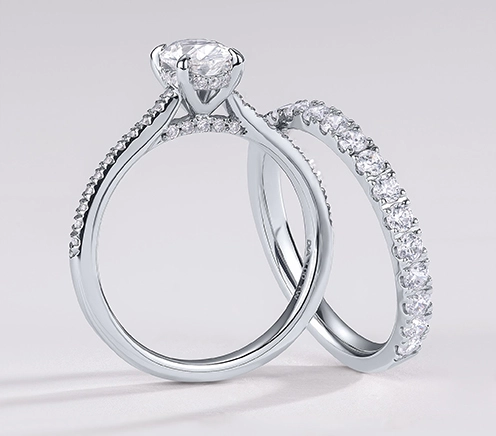 Two silver color rings on a gray background after professional jewelry retouching