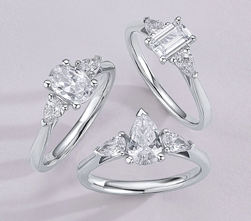 Three silver color rings on a gray background after professional jewelry retouching.