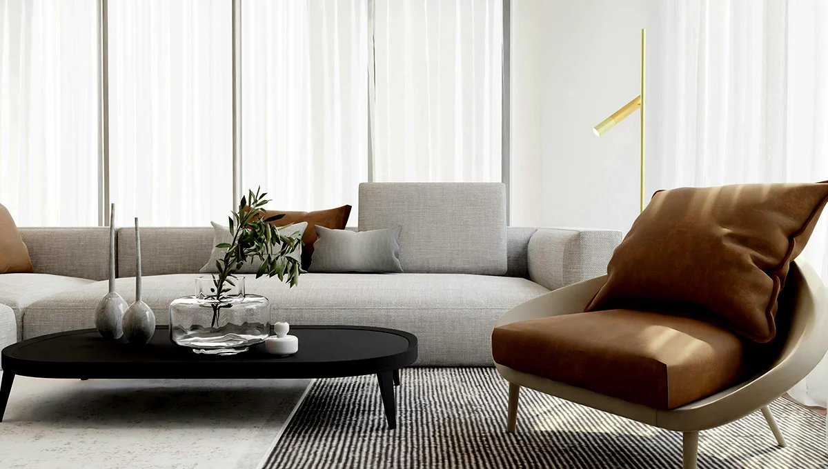 A contemporary living room with a sleek couch, a coffee table, and a chair, designed for comfort and style