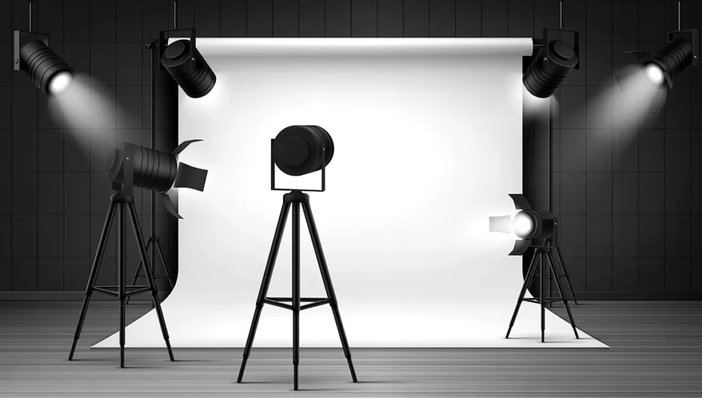 Photo studio featuring professional lights and a clean white backdrop, ideal for mastering studio photography lighting techniques.