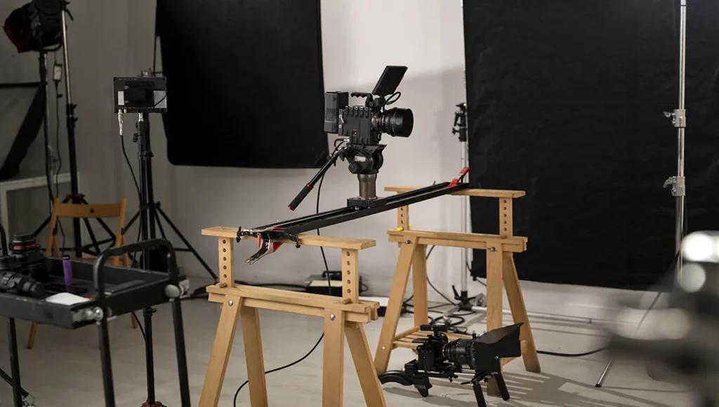 A camera and tripod arranged in a room, designed for product photography setup.